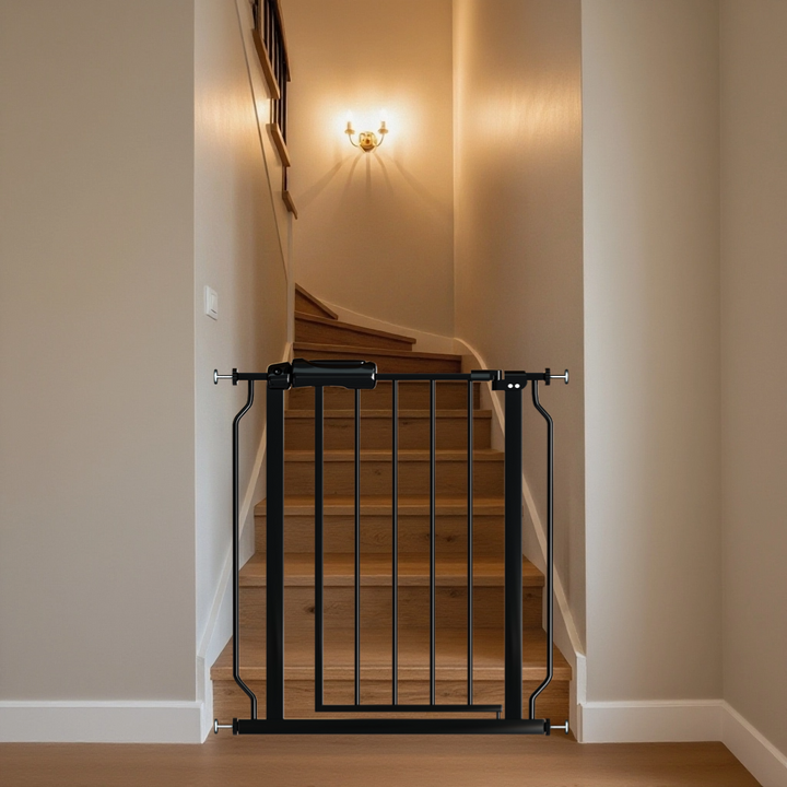 Black extra wide baby gate pressure mounted at the bottom of stairs