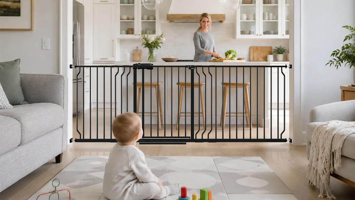 FairyBaby W046 extra wide walk-through baby safety gate installed in a living room, securing a toddler sitting on the floor.