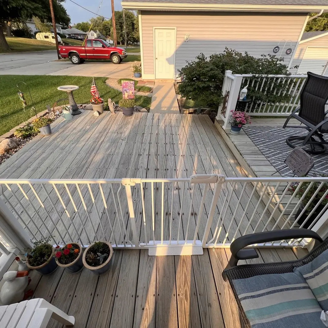 FairyBaby W046 extra wide safety gate installed on an outdoor wooden deck with multi extensions